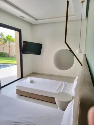 a bedroom with a bed and a large window at Villa Madjeyalia Soft Luxury in Marrakech