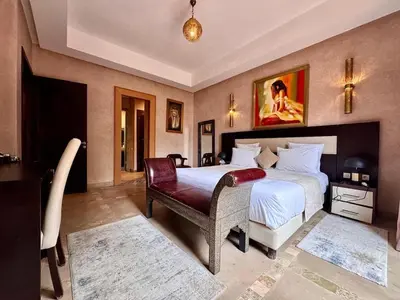 a large bedroom with a bed and a chair at Marrakech Luxury Escape Full Villa Pool & Garden in Sraghna