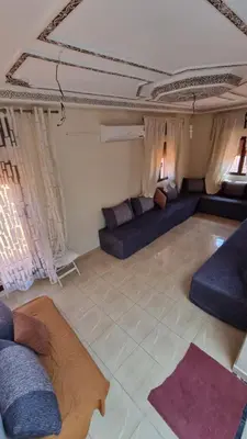 a living room with blue couches in a room at Appartement Atlas in Marrakech