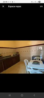 a kitchen with a white table and a stove at Appartement Atlas in Marrakech