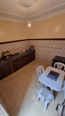 a kitchen with a table and chairs and a counter at Appartement Atlas in Marrakech