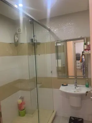 a bathroom with a glass shower and a sink at 2 Bedroom Apartment Calm Area Parking in Marrakech