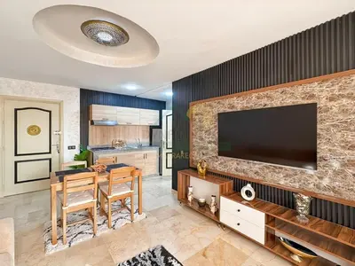 a living room with a table and a television on a wall at Confort Moderne au Cœur de Marrakech Proche Gare in Marrakech