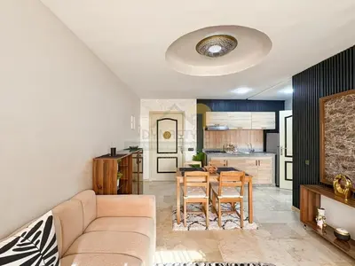 a living room with a couch and a table at Confort Moderne au Cœur de Marrakech Proche Gare in Marrakech