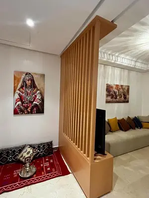 a living room with a couch and a television at Marrakchi Home, Vintage Terrace Overlooking Pool in Marrakech