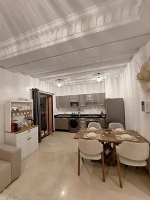 a kitchen and dining room with a table and chairs at Marrakchi Home, Vintage Terrace Overlooking Pool in Marrakech
