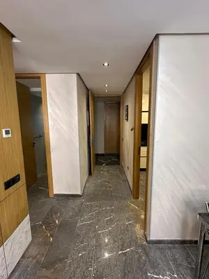 an empty hallway in a building with doors and a room at City Chic New build Apartment in Marrakech