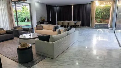 a large living room with couches and a table at Villa Oasis de Verre - Atlas Golf & Pool in Marrakech