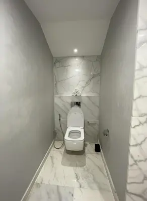 a white bathroom with a toilet in a room at Villa Oasis de Verre - Atlas Golf & Pool in Marrakech
