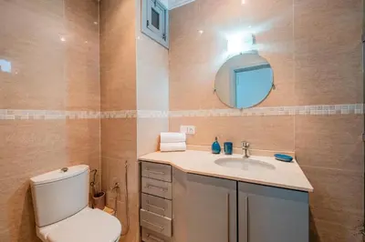 a bathroom with a toilet and a sink and a mirror at 1-Bedroom Apartment in Guéliz Center , 10 Min Jemaa El-Fna in Marrakech