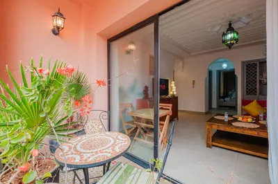 a patio with a table and chairs and a dining room at 1-Bedroom Apartment in Guéliz Center , 10 Min Jemaa El-Fna in Marrakech