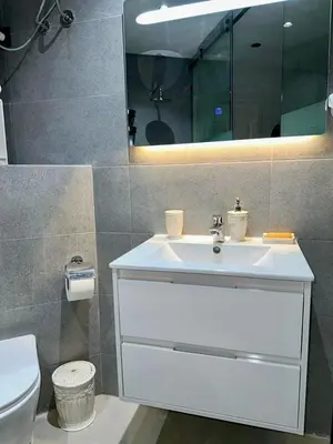 a bathroom with a sink and a toilet and a mirror at Apartment near Gueliz and Majorelle in Marrakech