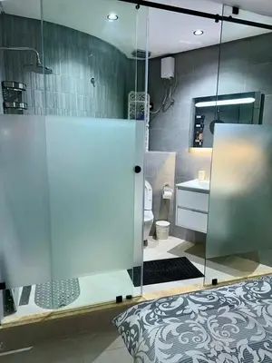 a bathroom with a glass shower and a toilet at Apartment near Gueliz and Majorelle in Marrakech