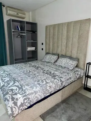 a bedroom with a large bed with a large headboard at Apartment near Gueliz and Majorelle in Marrakech