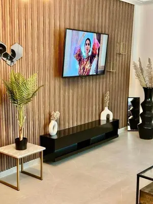 a living room with a flat screen tv on a wall at Apartment near Gueliz and Majorelle in Marrakech