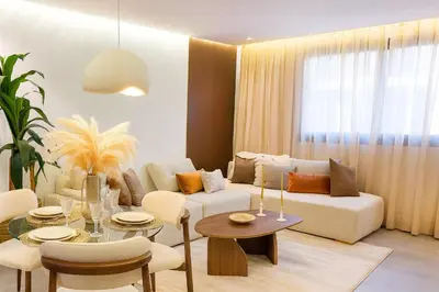 a living room with a couch and a table at Le Sahara Retreat - 2 prs - Piscine - Wifi in Marrakech