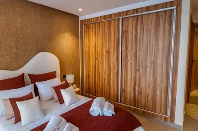 a bedroom with a bed and a large closet at Le Sahara Retreat - 2 prs - Piscine - Wifi in Marrakech
