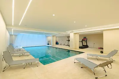 a large swimming pool with chairs and a gym at Le Sahara Retreat - 2 prs - Piscine - Wifi in Marrakech