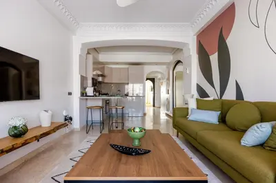 a living room with a green couch and a table at One bedroom studio in Guéliz, pool & gym in Marrakech
