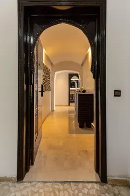 a hallway with an archway leading to a kitchen at One bedroom studio in Guéliz, pool & gym in Marrakech