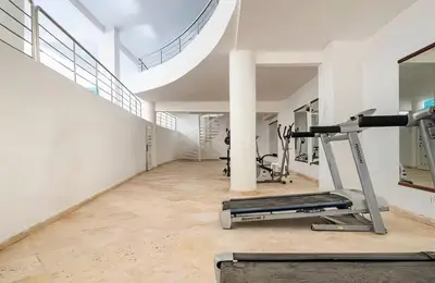 a gym with a treadmill and ellipticals in a building at One bedroom studio in Guéliz, pool & gym in Marrakech