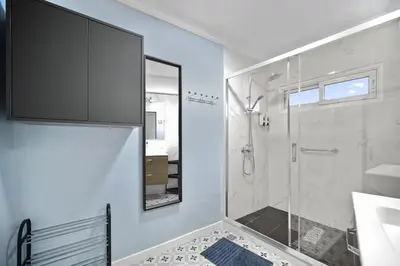 a bathroom with a shower and a sink and a mirror at Centre Town Cozy Apartment with Panoramic View in Marrakech