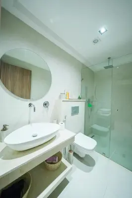 a white bathroom with a sink and a shower at Modern apartments, cozy residence, swimming pools in Marrakech