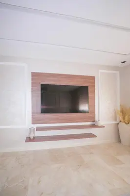 a living room with a flat screen tv on a wall at Modern apartments, cozy residence, swimming pools in Marrakech