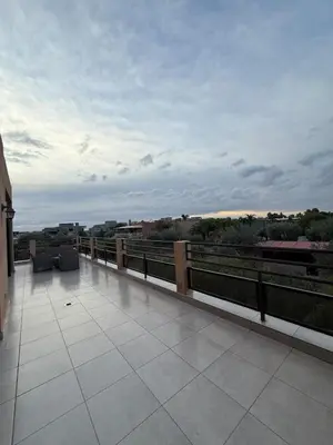a balcony of a building with a view of the city at Cozy Flat , Resort-Style Pool ,10 min to Center in Marrakech