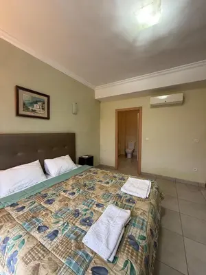 a bedroom with a large bed with towels on it at Cozy Flat , Resort-Style Pool ,10 min to Center in Marrakech