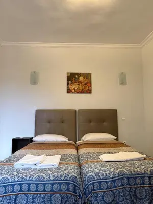 two beds sitting next to each other in a room at Cozy Flat , Resort-Style Pool ,10 min to Center in Marrakech