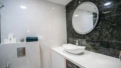 a bathroom with a sink and a mirror at Appartement Chic avec Piscine au Cœur de Gueliz in Marrakech