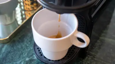 a coffee being poured into a coffee cup at Appartement Chic avec Piscine au Cœur de Gueliz in Marrakech