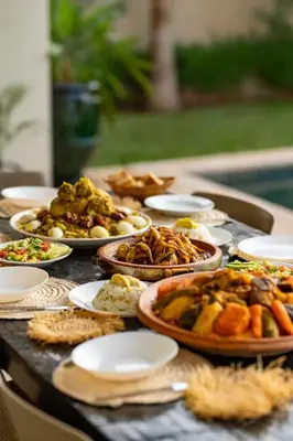 a table with many plates of food on it at Momiji Golf Villa - Private Heated Pool in Marrakech