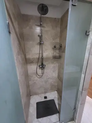 a bathroom with a shower with a glass door at Luxury Apartment Les Cerisiers Marrakech in Marrakech