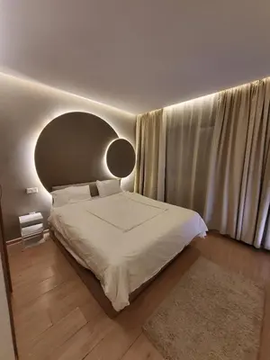 a bedroom with a large bed and a large window at Luxury Apartment Les Cerisiers Marrakech in Marrakech