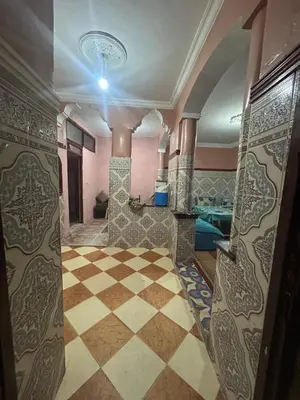 a room with a checkered floor and a room with a ceiling at Maison confortable pour familles in Zaouia El Hedil Mamra