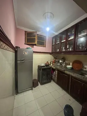 a kitchen with a refrigerator and a stove at Maison confortable pour familles in Zaouia El Hedil Mamra