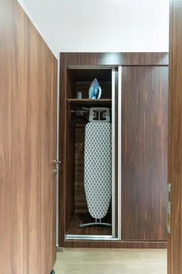 an open door to a closet with a surfboard in it at Menara Suite Harmonie , Terrasse et Piscine in Marrakech