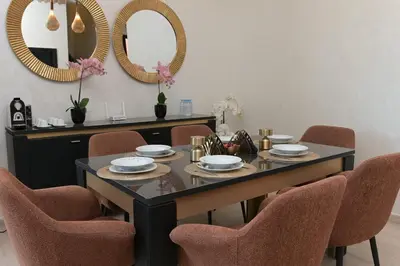 a dining room with a table with chairs and mirrors at Villa Sara - 3 Rooms with private pool in Marrakech