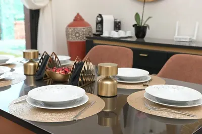 a dining room table with plates and napkins on it at Villa Sara - 3 Rooms with private pool in Marrakech
