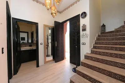 a hallway with stairs and a bathroom with a mirror at Villa Sara - 3 Rooms with private pool in Marrakech
