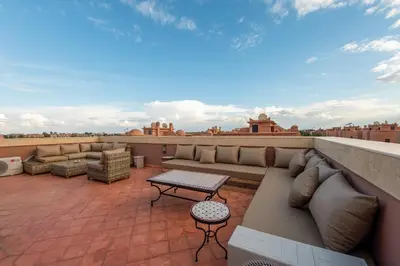 a patio with couches and a table on a roof at Villa Sara - 3 Rooms with private pool in Marrakech