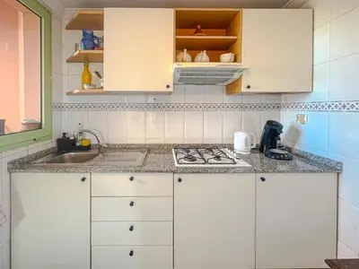 a kitchen with white cabinets and a sink at Séjour Élégant et raffiné à Hivernage 2 ch & parking privé in Marrakech