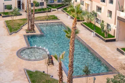 an overhead view of a pool in a courtyard with palm trees at Le Lotus - Piscine intérieur et extérieur - Wifi - Fitness in Marrakech