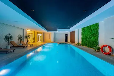 a large swimming pool in a building with a pool at Le Lotus - Piscine intérieur et extérieur - Wifi - Fitness in Marrakech