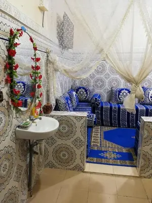 a bathroom with blue and white walls and a sink at famile 154 in Marrakech