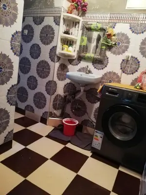 a bathroom with a washing machine and a sink at famile 154 in Marrakech