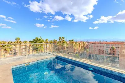 a swimming pool on the roof of a building at Private Luxury Penthouse Marrakech with Jacuzzi & Pool in Marrakech