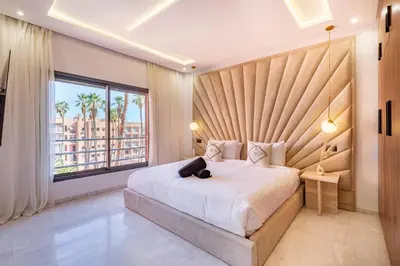 a bedroom with a large bed and a large window at Private Luxury Penthouse Marrakech with Jacuzzi & Pool in Marrakech